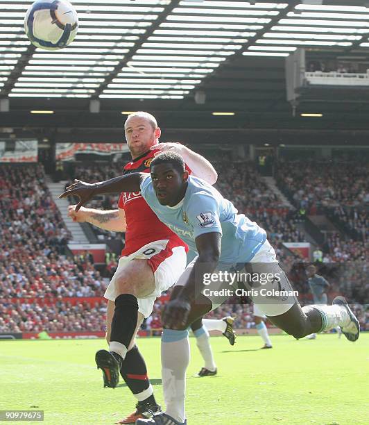 Wayne Rooney of Manchester United clashes with Micah Richards of Manchester City during the FA Barclays Premier League match between Manchester...