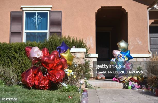 Balloons, flowers and other momentos are left in front of the Turpin family's home in Perris, California on January 24 ahead of another court hearing...