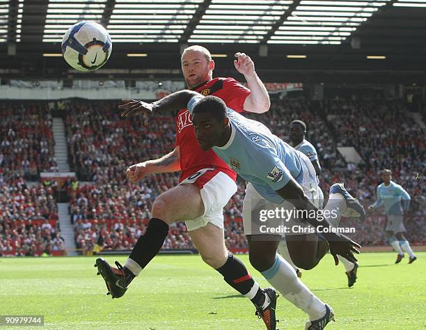 Wayne Rooney of Manchester United clashes with Micah Richards of Manchester City during the FA Barclays Premier League match between Manchester...