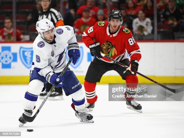 Tyler Johnson of the Tampa Bay Lightning controls the puck in front of Patrick Kane of the Chicago Blackhawks at the United Center on January 22,...