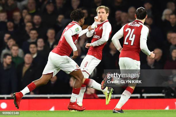 Arsenal's Spanish defender Nacho Monreal celebrates scoring the team's first goal during the League Cup semi-final football match between Arsenal and...