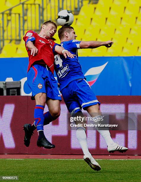 Aleksei Berezutskiy of PFC CSKA Moscow battles for the ball with Marcin Kowalczyk of FC Dynamo Moscow during the Russian Football League Championship...