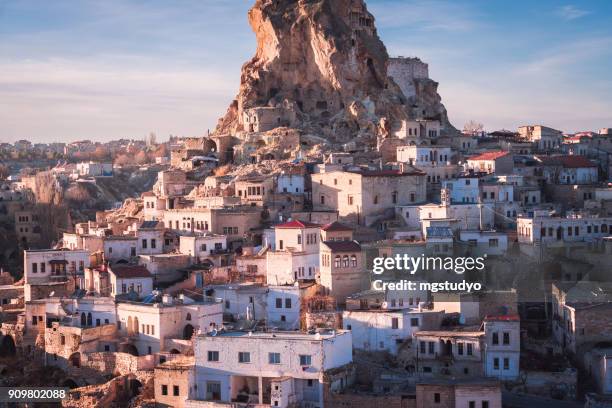 ortahisar cave city in cappadocia, turkey on sunset - ortahisar stock pictures, royalty-free photos & images