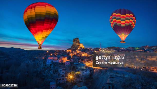 ortahisar cave city in cappadocia, turkey on sunset - cappadocia hot air balloon stock pictures, royalty-free photos & images