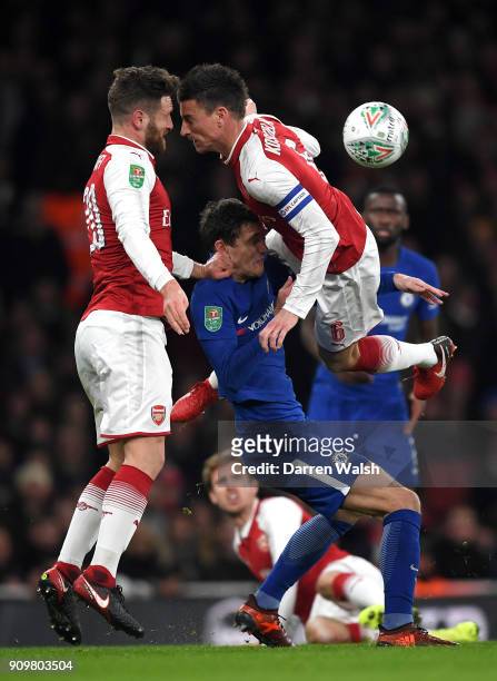Andreas Christensen of Chelsea is tackled from both sides by Shkodran Mustafi and Laurent Koscielny of Arsenal during the Carabao Cup Semi-Final...