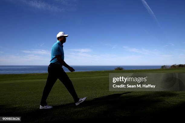 Tiger Woods walks along the 16th fairway on the during the pro-am round of the Farmers Insurance Open at Torrey Pines Golf Course on January 24, 2018...