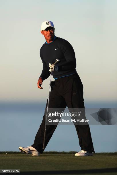 Tiger Woods watches his tee on the 11th hole during the pro-am round of the Farmers Insurance Open at Torrey Pines Golf Course on January 24, 2018 in...