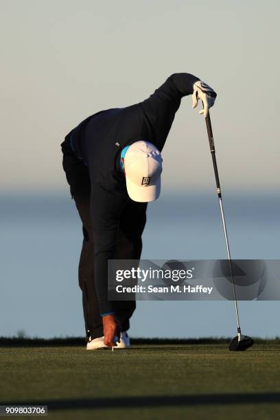 Tiger Woods places his ball on a tee at the 11th hole during the pro-am round of the Farmers Insurance Open at Torrey Pines Golf Course on January...