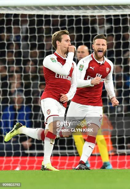 Arsenal's Spanish defender Nacho Monreal celebtrates scoring the team's first goal with Arsenal's German defender Shkodran Mustafi during the League...