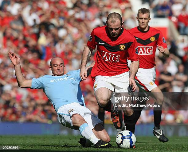 Wayne Rooney of Manchester United clashes with Stephen Ireland of Manchester City during the Barclays Premier League match between Manchester United...