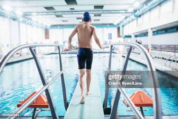 boy in pool on diving board - diving board stock pictures, royalty-free photos & images