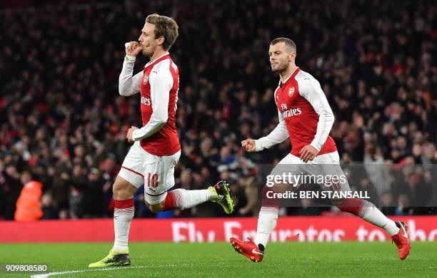 Arsenal's Spanish defender Nacho Monreal celebrates scoring the team's first goal during the League Cup semi-final football match between Arsenal and...