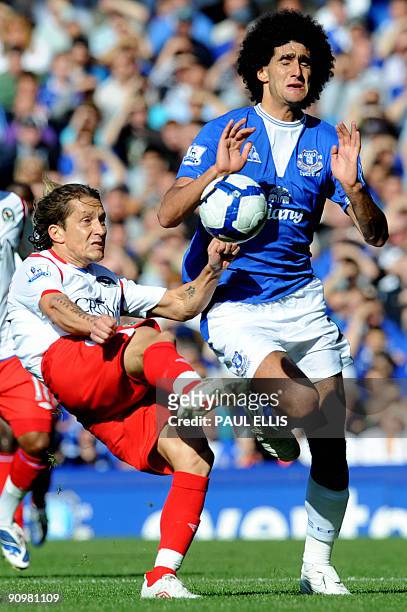 Blackburn Rovers' Spanish defender Michel Salgado clears the ball away from Everton's Belgian midfielder Marouane Fellaini during their English...