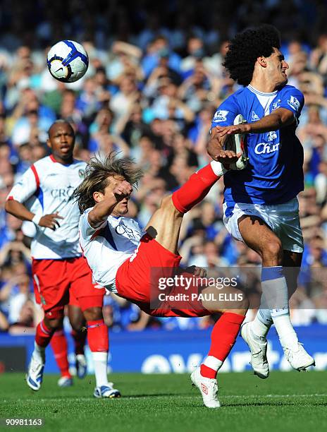 Blackburn Rovers' Spanish defender Michel Salgado clears the ball away from Everton's Belgian midfielder Marouane Fellaini during their English...