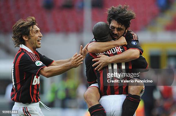 Clarence Seedorf of AC Milan celebrates his opening goal with Gennaro Gattuso and Andrea Pirlo during the Serie A match between AC Milan and Bologna...