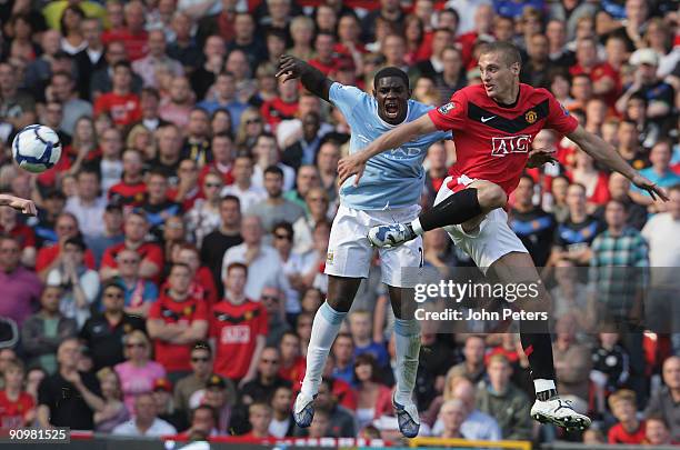 Nemanja Vidic of Manchester United clashes with Micah Richards of Manchester City during the FA Barclays Premier League match between Manchester...