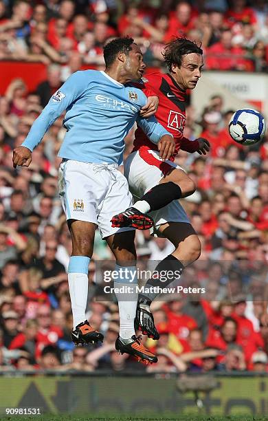 Dimitar Berbatov of Manchester United clashes with Joleon Lescott of Manchester City during the Barclays Premier League match between Manchester...