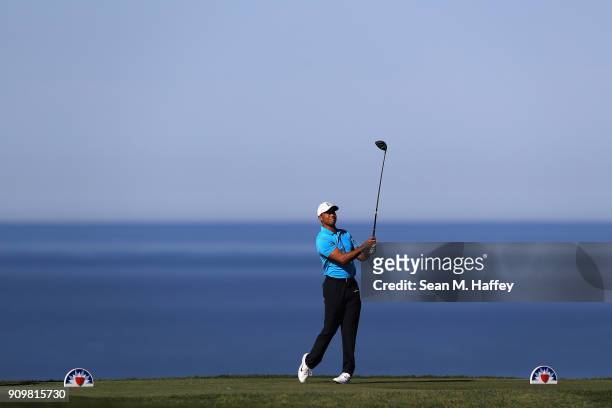 Tiger Woods hits a tee shot on the 17th hole during the pro-am of the Farmers Insurance Open at Torrey Pines Golf Course on January 24, 2018 in San...