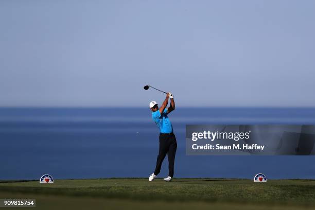 Tiger Woods hits a tee shot on the 17th hole during the pro-am of the Farmers Insurance Open at Torrey Pines Golf Course on January 24, 2018 in San...