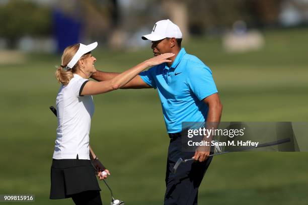 Tiger Woods hugs Kathy Cody after finishing the pro-am round of the Farmers Insurance Open at Torrey Pines Golf Course on January 24, 2018 in San...