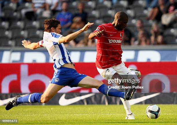 Arne Friedrich of Berlin and Mohamadou Idrissou of Freiburg battle for the ball during the Bundesliga match between Hertha BSC Berlin and SC Freiburg...