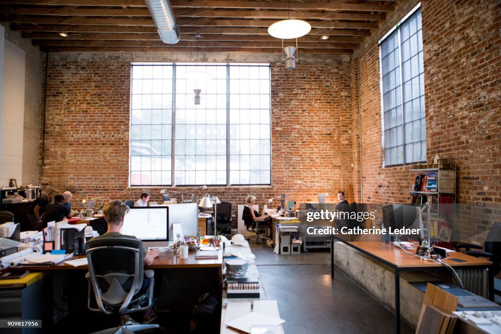 Wide Shot of Architect's Office with Brick walls and high ceilings