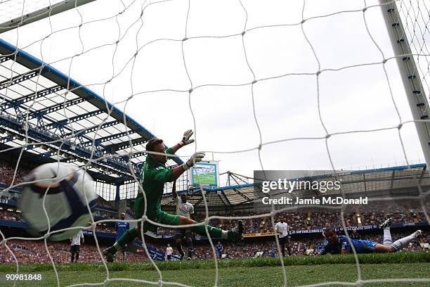 Ashley Cole of Chelsea scores past Tottenham Hotspur goalkeeper Carlo Cudicini during the Barclays Premier League match between Chelsea and Tottenham...