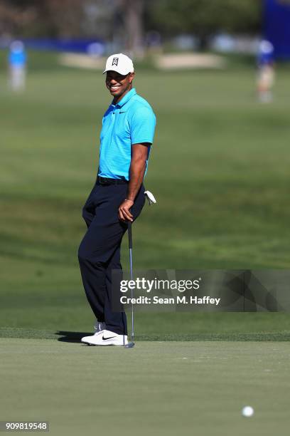 Tiger Woods looks on at the 18th green during the pro-am round of the Farmers Insurance Open at Torrey Pines Golf Course on January 24, 2018 in San...