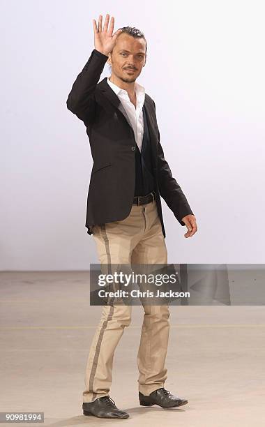 Designer Matthew Williamson waves as he walks down the runway at the Matthew Williamson Spring/Summer 2010 show at Howick Place during London Fashion...