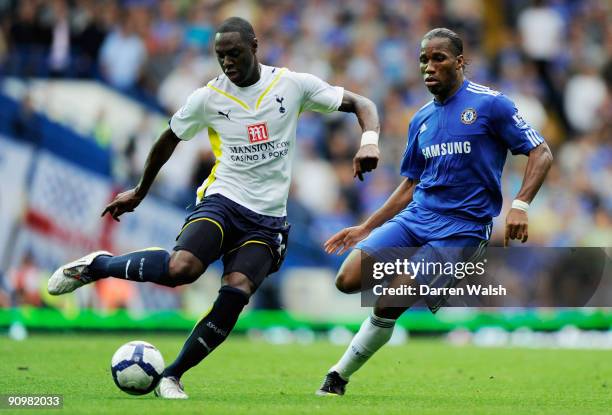 Ledley King of Spurs clears the ball as Didier Drogba of Chelsea closes in during the Barclays Premier League match between Chelsea and Tottenham...