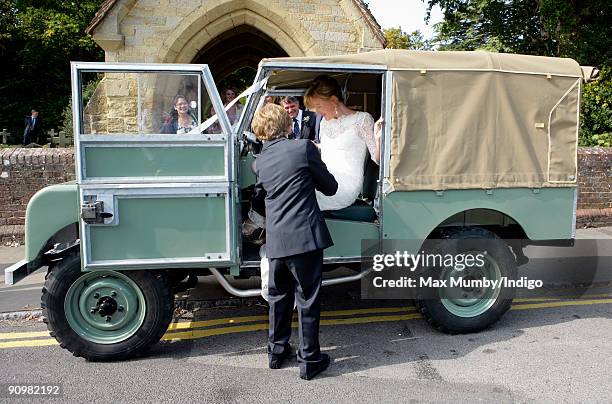 Eimear Montgomerie is helped into a canvas roofed Land Rover as she leaves St. Nicholas Church after her wedding to Nick Cook on September 20, 2009...
