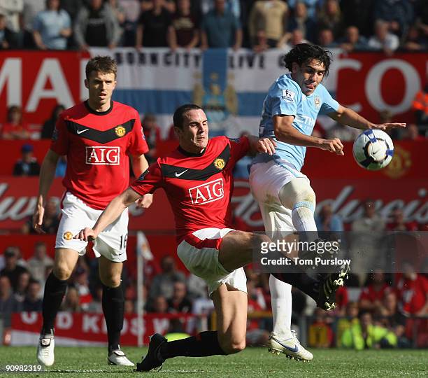 John O'Shea of Manchester United clashes with Carlos Tevez and Joleon Lescott of Manchester City during the Barclays Premier League match between...