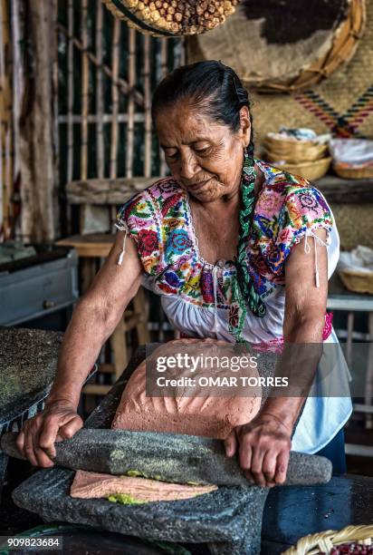 Herlinda Olivos Ramirez molds tortilla dough in her restaurant on October 5, 2016 at the Mole Fair in San Pedro Atocpan, Milpa Alta borough, near...