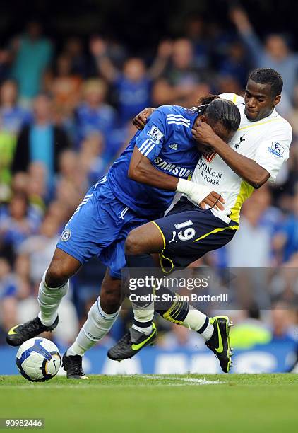 Didier Drogba of Chelsea battles for the ball with Sebastien Bassong of Tottenham Hotspur during the Barclays Premier League match between Chelsea...