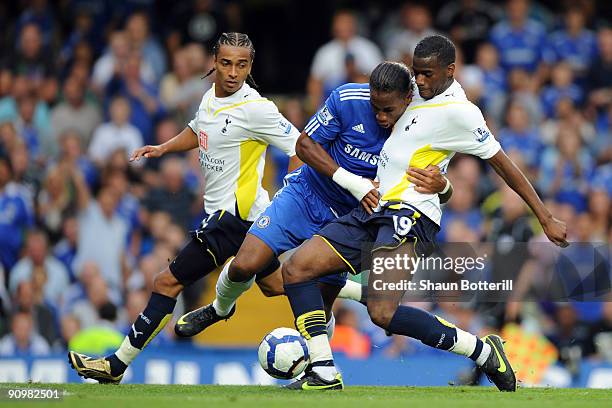 Didier Drogba of Chelsea battles for the ball with Sebastien Bassong of Tottenham Hotspur during the Barclays Premier League match between Chelsea...