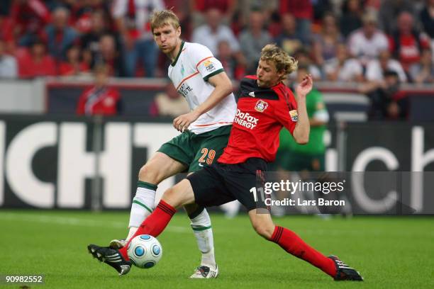 Per Mertesacker of Bremen is challenged by Stefan Kiessling of Leverkusen during the Bundesliga match between Bayer Leverkusen and Werder Bremen at...