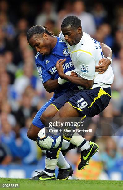 Didier Drogba of Chelsea battles for the ball with Sebastien Bassong of Tottenham Hotspur during the Barclays Premier League match between Chelsea...