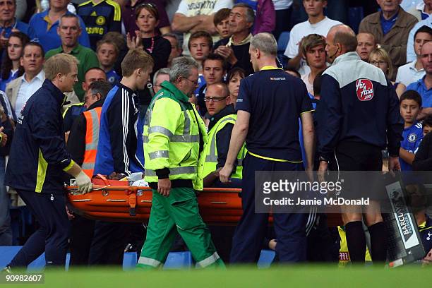 Sebastien Bassong of Tottenham Hotspur is taken off the pitch during the Barclays Premier League match between Chelsea and Tottenham Hotspur at...