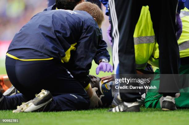 Sebastien Bassong of Spurs receives medical attention after a collision with Nicolas Anelka of Chelsea during the Barclays Premier League match...