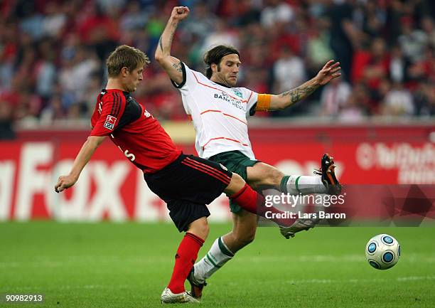 Toni Kroos of Leverkusen is challenged by Torsten Frings of Bremen during the Bundesliga match between Bayer Leverkusen and Werder Bremen at BayArena...