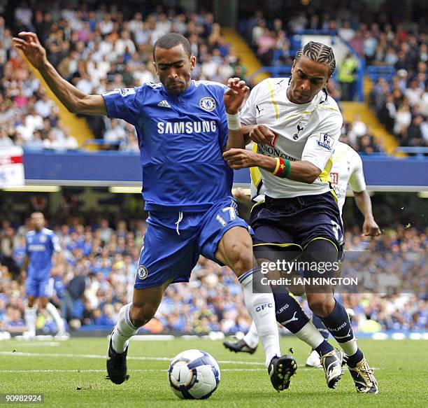 Chelsea's Portugese player Jose Bosingwa is challenged by Tottenham Hotspurs Cameroon player Benoit Assou-Ekotto during a Premier League match at...