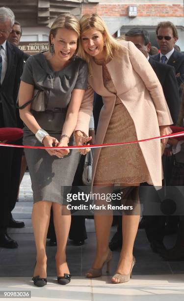 Princess Mathilde from Belgium and Princess Maxima from The Netherlands cut the red ribbon to inaugurate the "M" Museum on September 20, 2009 in...