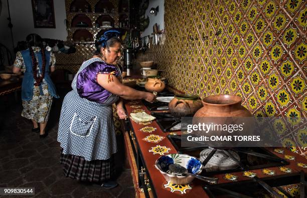 Chefs Abigail Mendoza and Rufina Mendoza cook pumpkin flower soup in their Tlamanalli restaurant on February 25, 2017 in Teotitlan del Valle, Oaxaca...