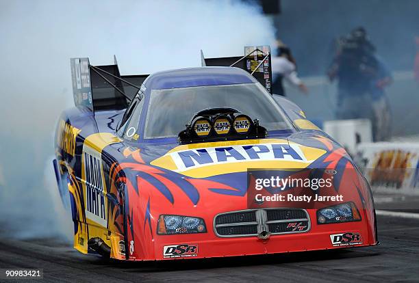 Ron Capps, driver of the NAPA Dodge funny car heats his tires during the NHRA Carolinas Nationals on September 20, 2009 at Zmax Dragway in Concord,...