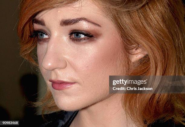 Singer Nicola Roberts smiles in the front row of the Unique Spring/Summer 2010 show at the TopShop Show Space during London Fashion Week on September...