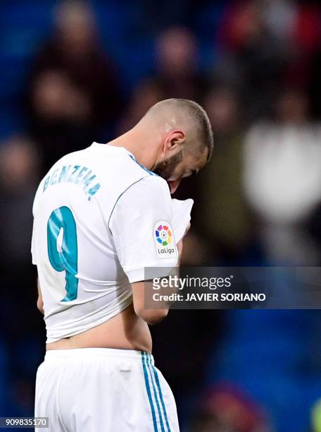 Real Madrid's French forward Karim Benzema leaves the field at the end of the Spanish 'Copa del Rey' quarter-final second leg football match between...