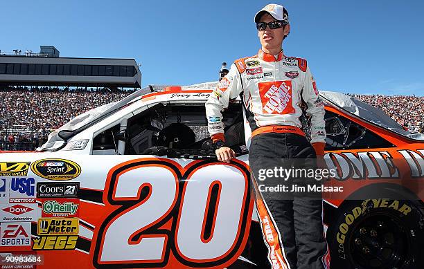 Joey Logano, driver of the Home Depot Toyota, looks from on the grid prior to the NASCAR Sprint Cup Series Sylvania 300 at the New Hampshire Motor...