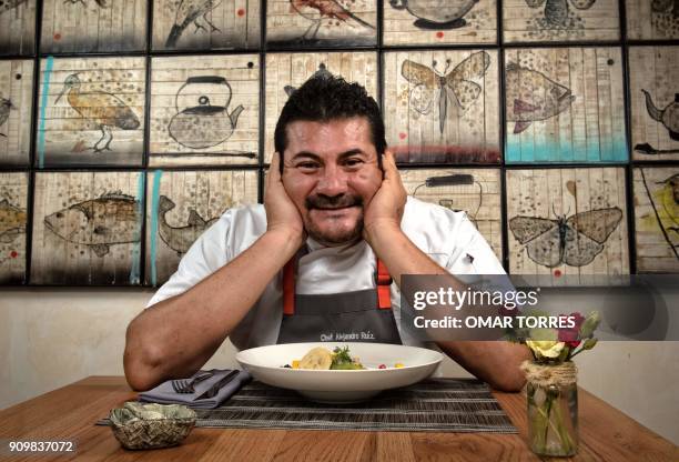 Chef Alejandro Ruiz poses for a picture with his "chile de agua" dish, prepared with ceviche, mango, passion fruit, brown sugar and cinnamon sauce,...