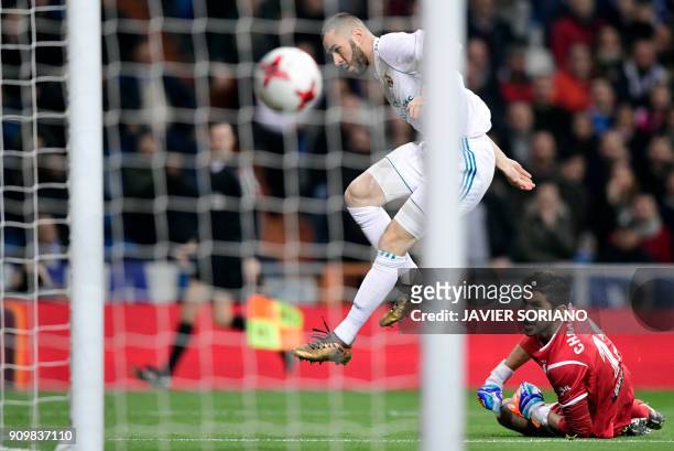Real Madrid's French forward Karim Benzema shoots to score a goal during the Spanish 'Copa del Rey' quarter-final second leg football match between...