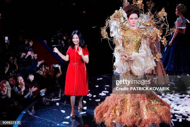 Chinese Fashion designer Guo Pei acknowledges the audience at the end of her fashion show during the 2018 spring/summer Haute Couture collection on...